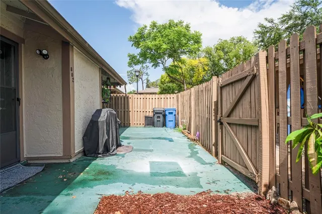 a view of backyard with small cabin and wooden fence