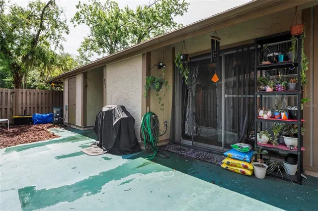 a backyard of a house with barbeque oven table and chairs