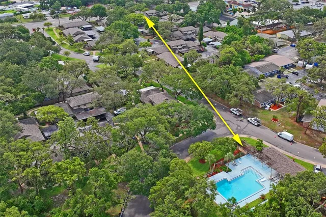 an aerial view of a residential houses with outdoor space and street view