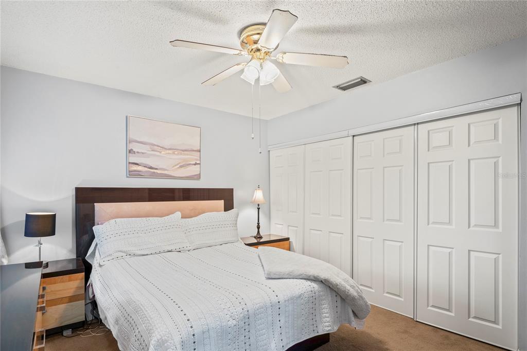 802 Antler Court Brandon, FL 33511 - Photo 10 of 37 a bedroom with a bed and a chandelier