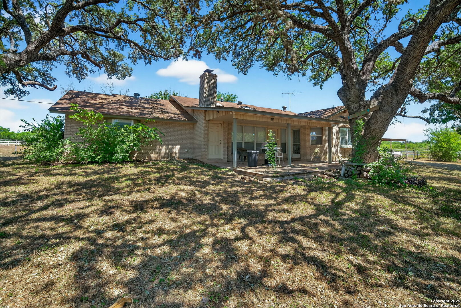 281 County Road 265 Mico, TX 78056 - Photo 1 of 28 a front view of a house with garden