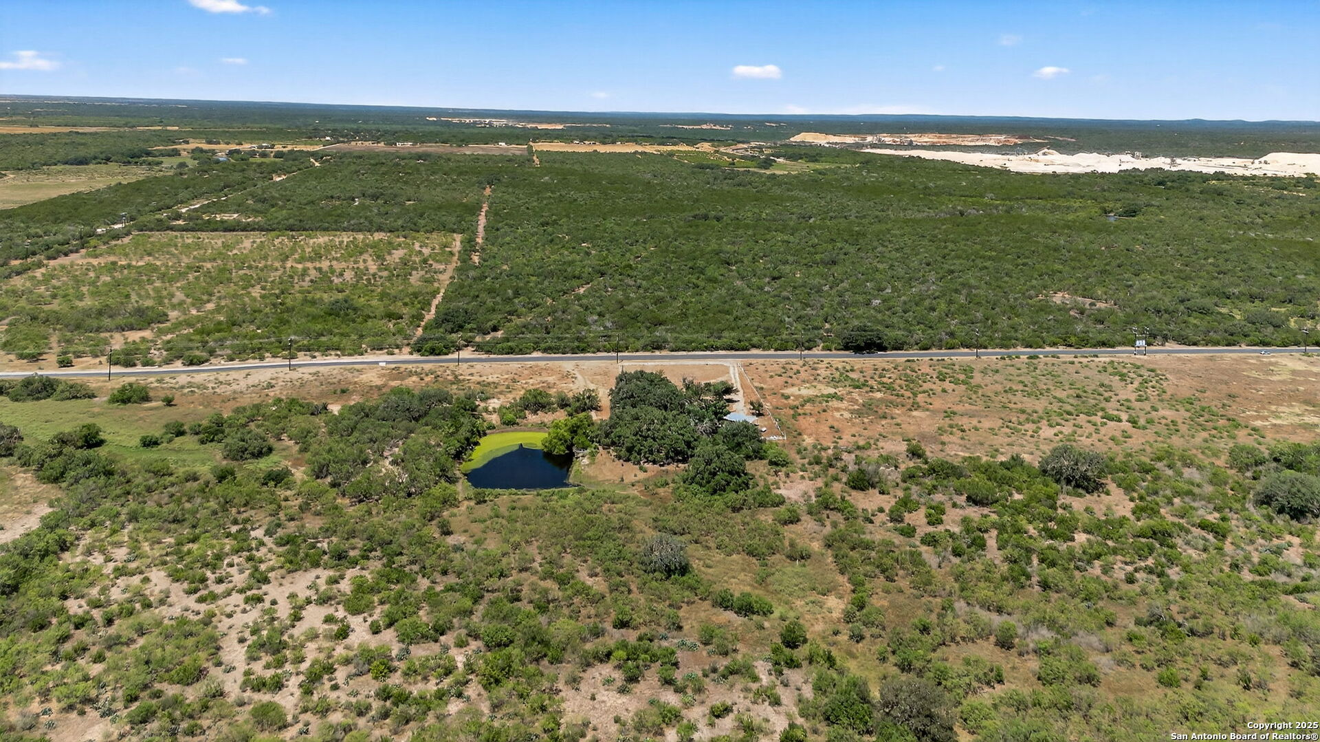281 County Road 265 Mico, TX 78056 - Photo 18 of 28 a view of a lake from a yard