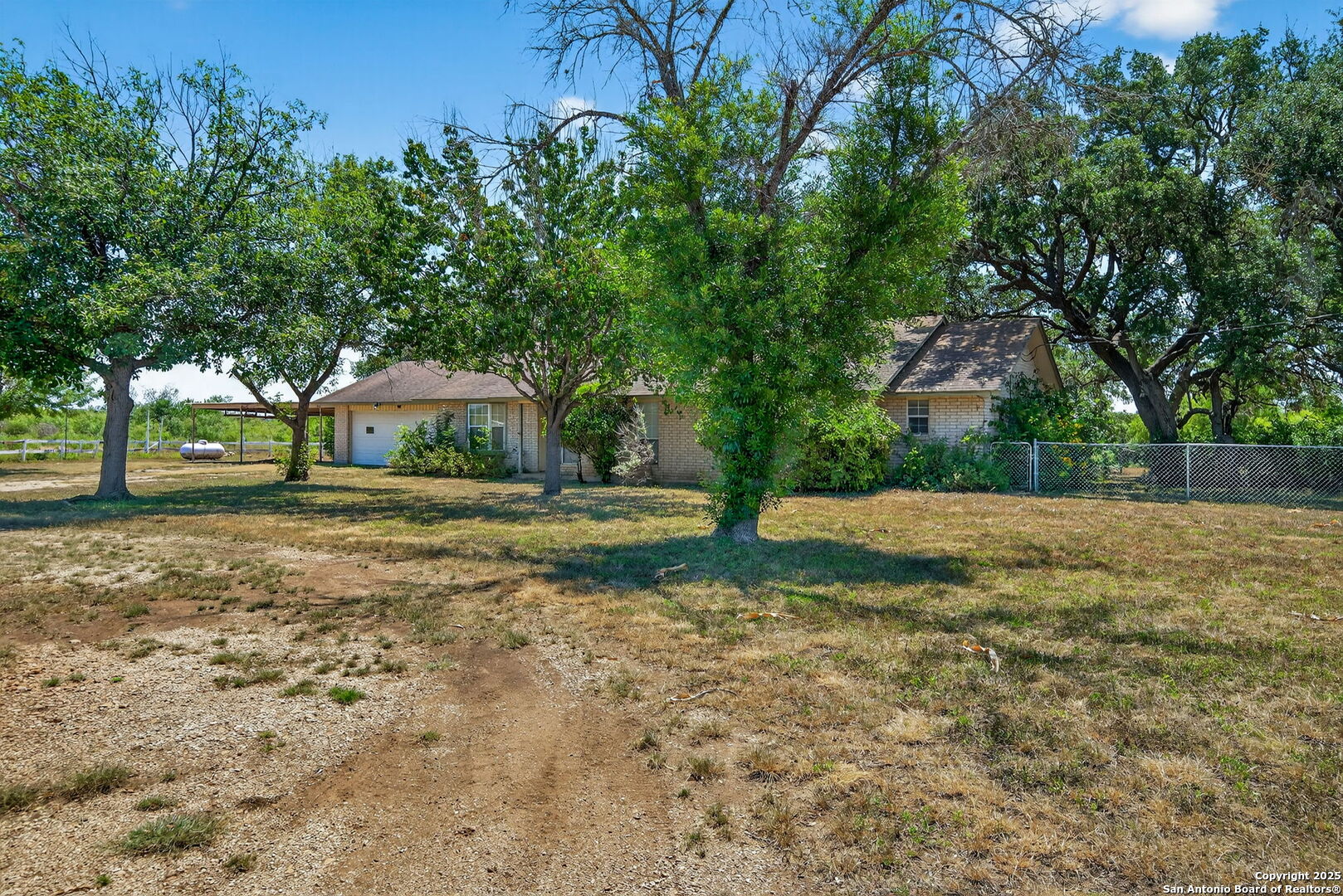 281 County Road 265 Mico, TX 78056 - Photo 2 of 28 a house view with outdoor space