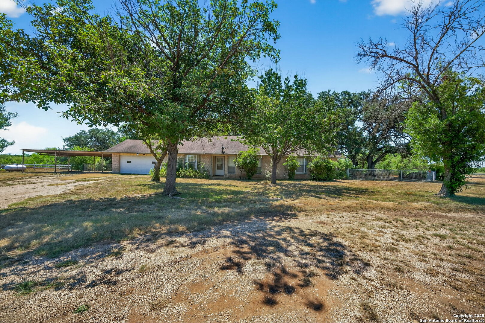 281 County Road 265 Mico, TX 78056 - Photo 22 of 28 a view of a yard with plants and trees