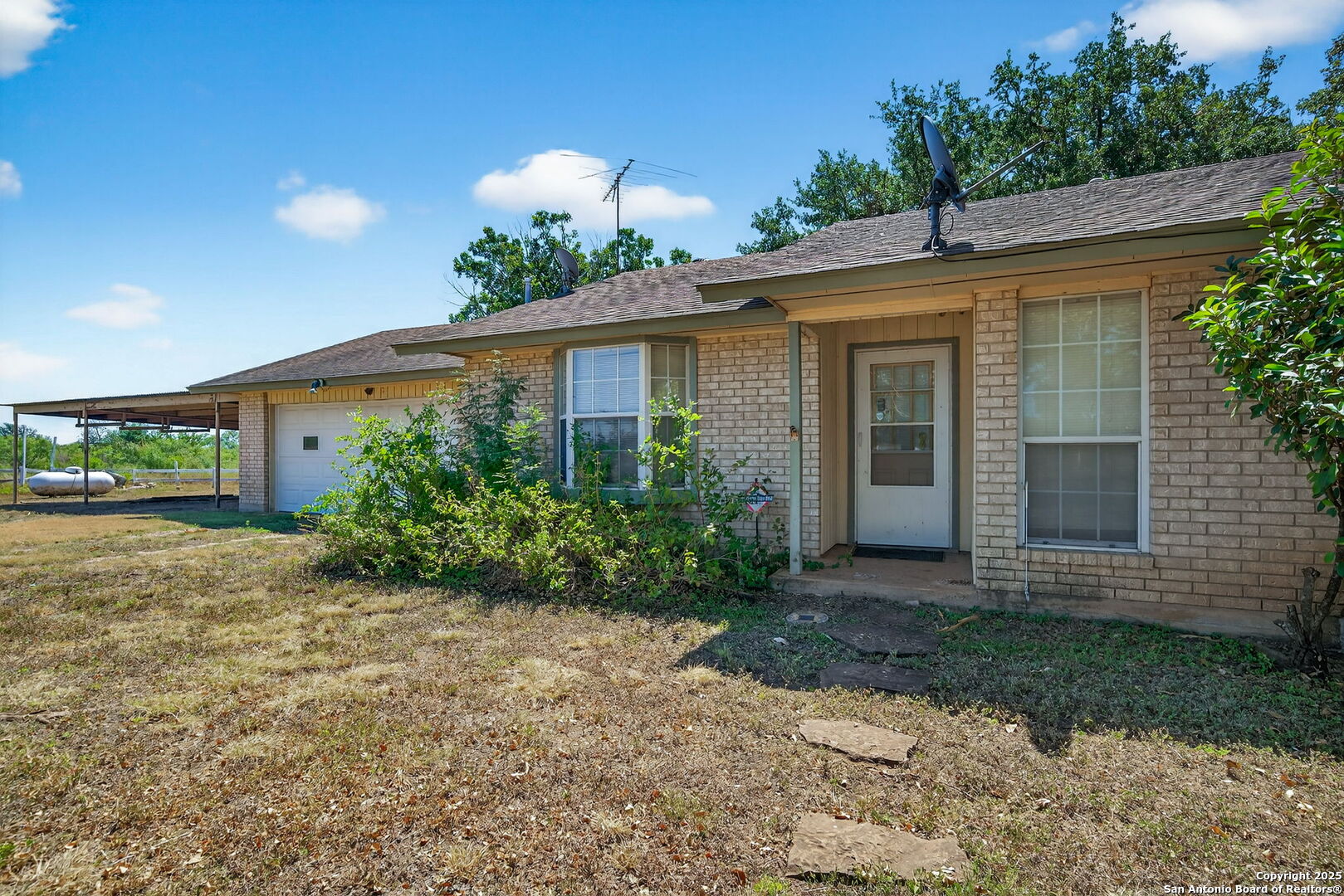 281 County Road 265 Mico, TX 78056 - Photo 24 of 28 a front view of a house with garden