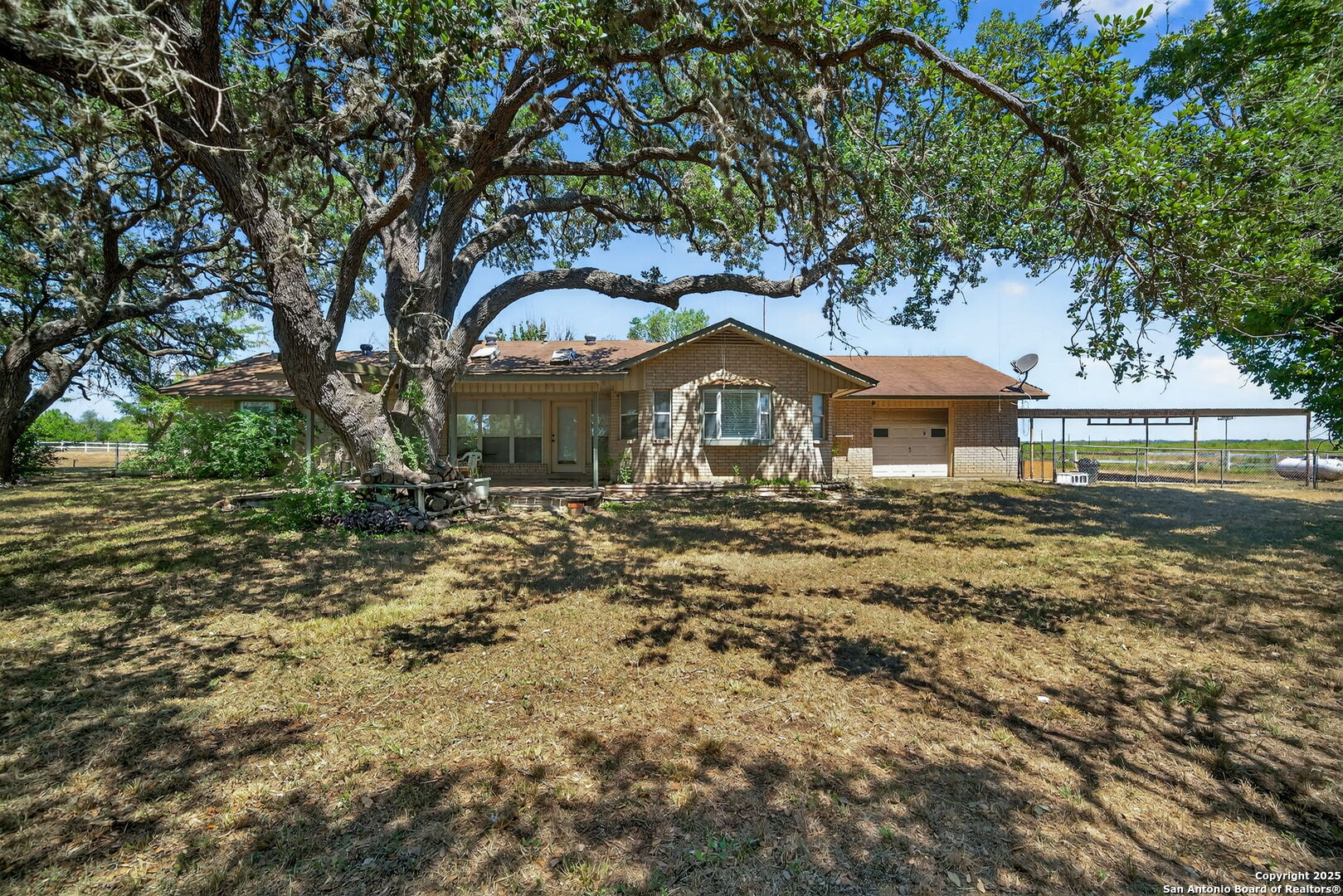 281 County Road 265 Mico, TX 78056 - Photo 27 of 28 a front view of a house with a garden