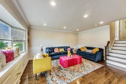 a living room with furniture rug and window