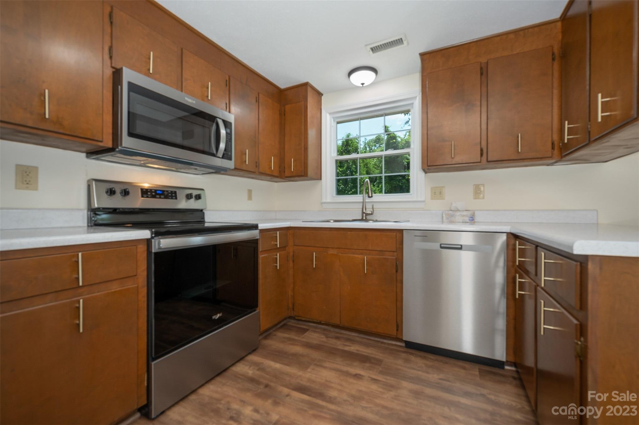 980 Brookside Camp Road Hendersonville, NC 28792 - Photo 12 of 47 a kitchen with stainless steel appliances granite countertop a stove a sink dishwasher a microwave oven with granite countertops and cabinets