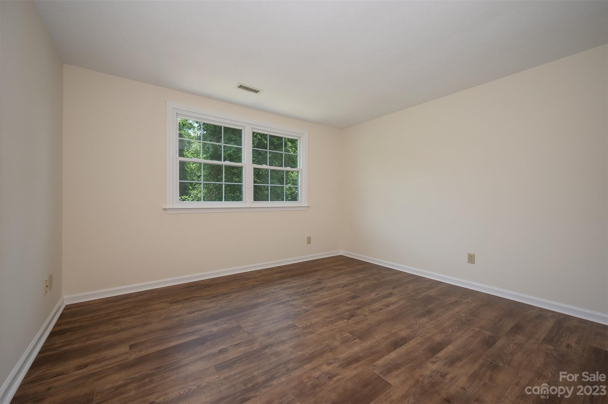 980 Brookside Camp Road Hendersonville, NC 28792 - Photo 20 of 47 an empty room with wooden floor and windows