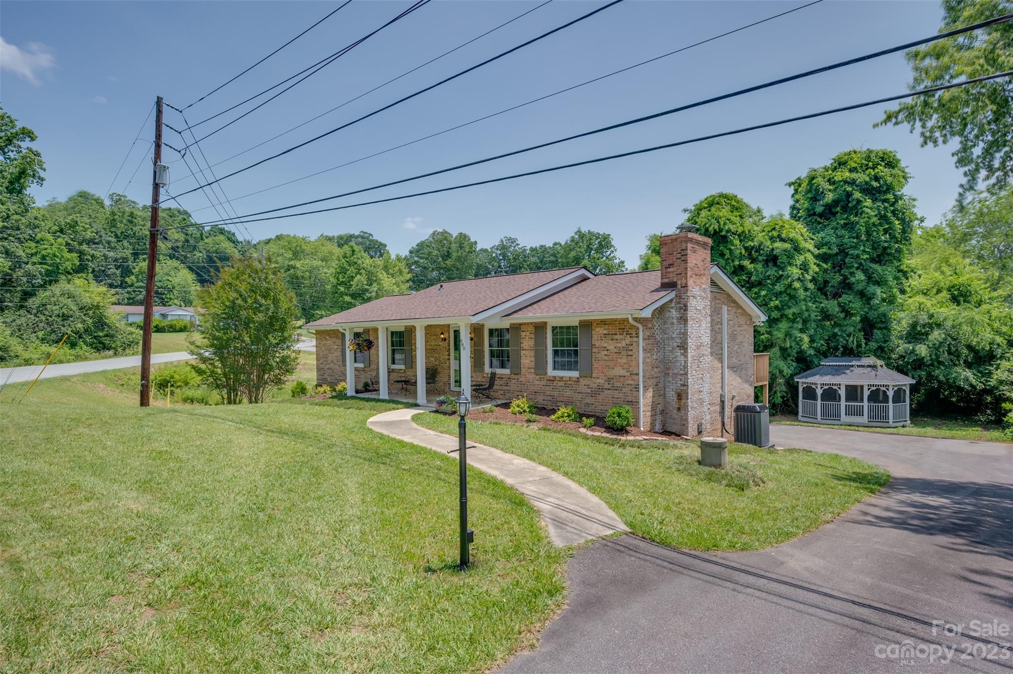 980 Brookside Camp Road Hendersonville, NC 28792 - Photo 2 of 47 a front view of a house with a yard