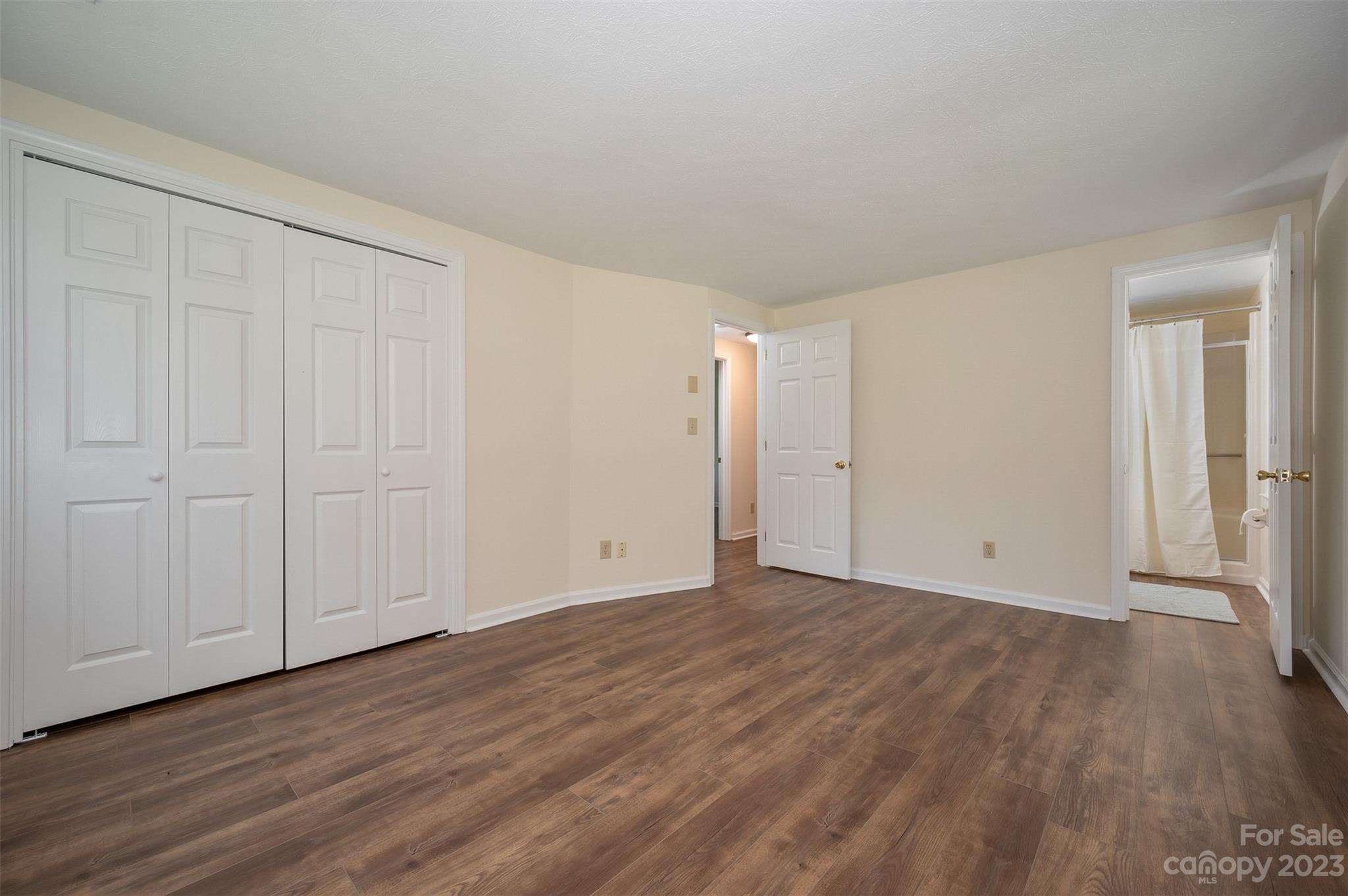 980 Brookside Camp Road Hendersonville, NC 28792 - Photo 25 of 47 a view of an empty room with wooden floor