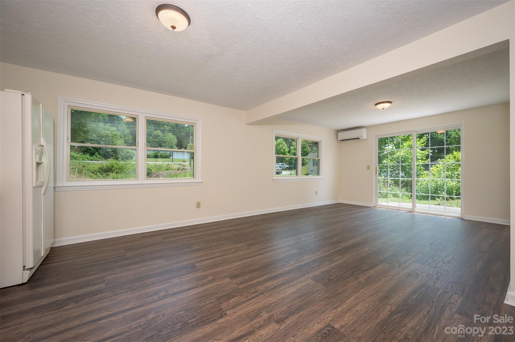 980 Brookside Camp Road Hendersonville, NC 28792 - Photo 28 of 47 a view of an empty room with wooden floor and windows