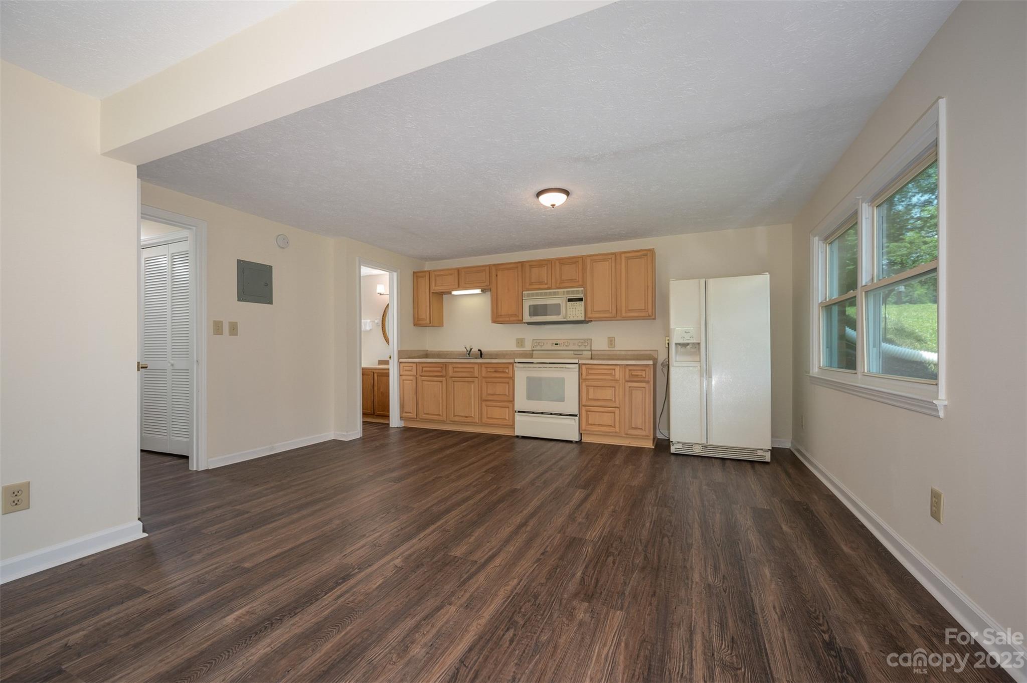 980 Brookside Camp Road Hendersonville, NC 28792 - Photo 30 of 47 a view of a kitchen with a fridge wooden floor and a window