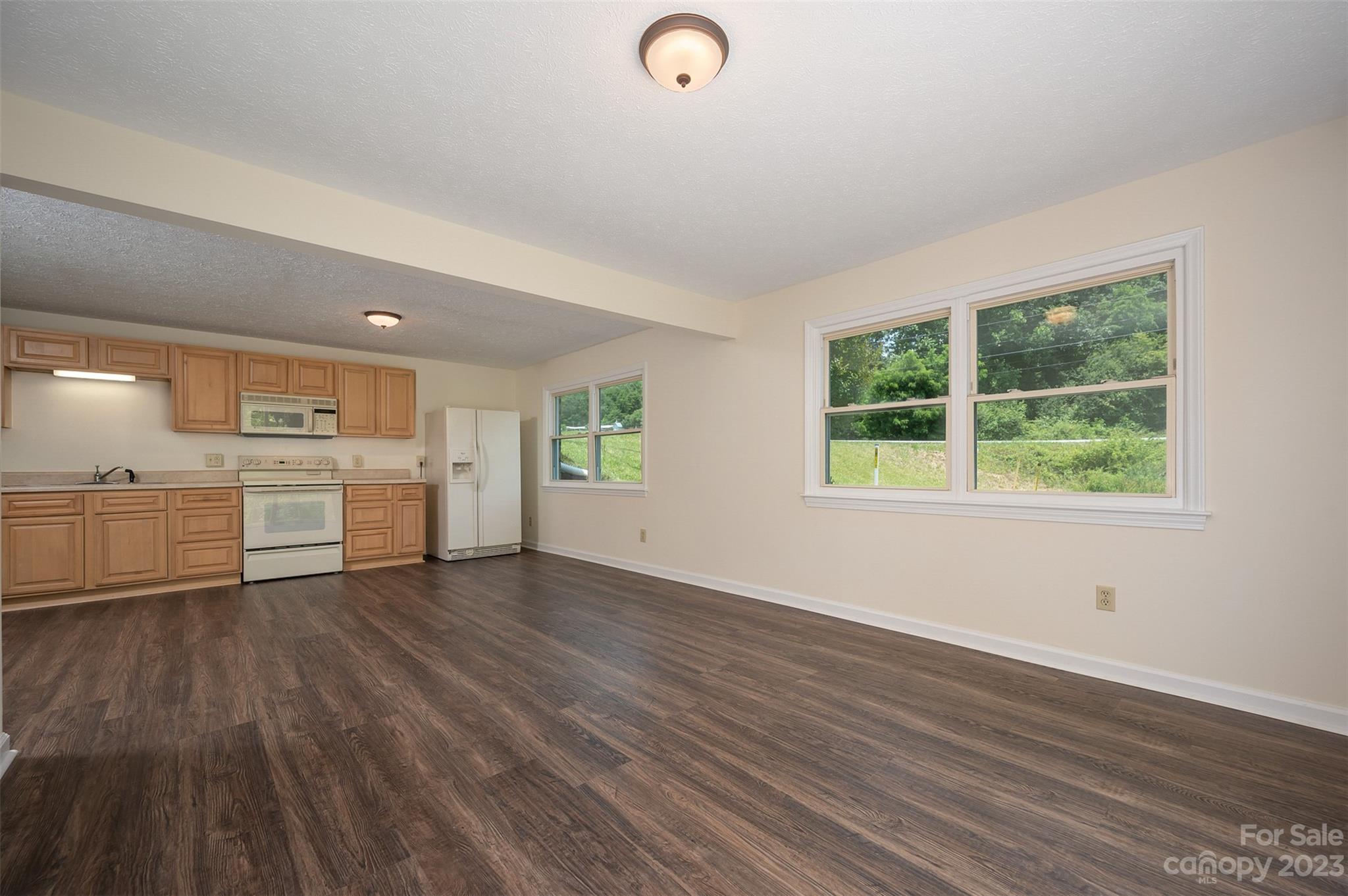 980 Brookside Camp Road Hendersonville, NC 28792 - Photo 31 of 47 a view of a kitchen with wooden floor and electronic appliances