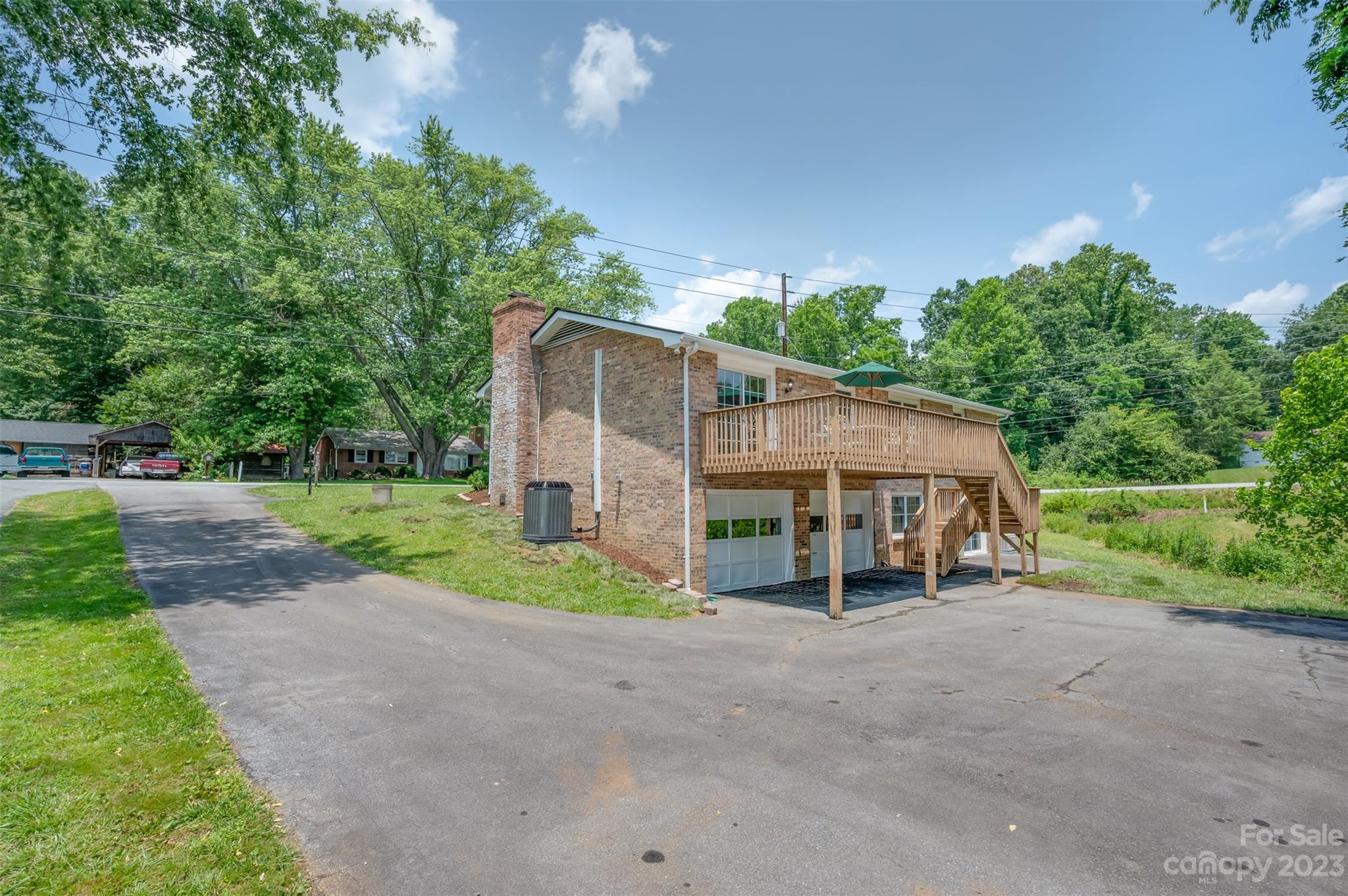 980 Brookside Camp Road Hendersonville, NC 28792 - Photo 36 of 47 a view of a house with backyard and trees