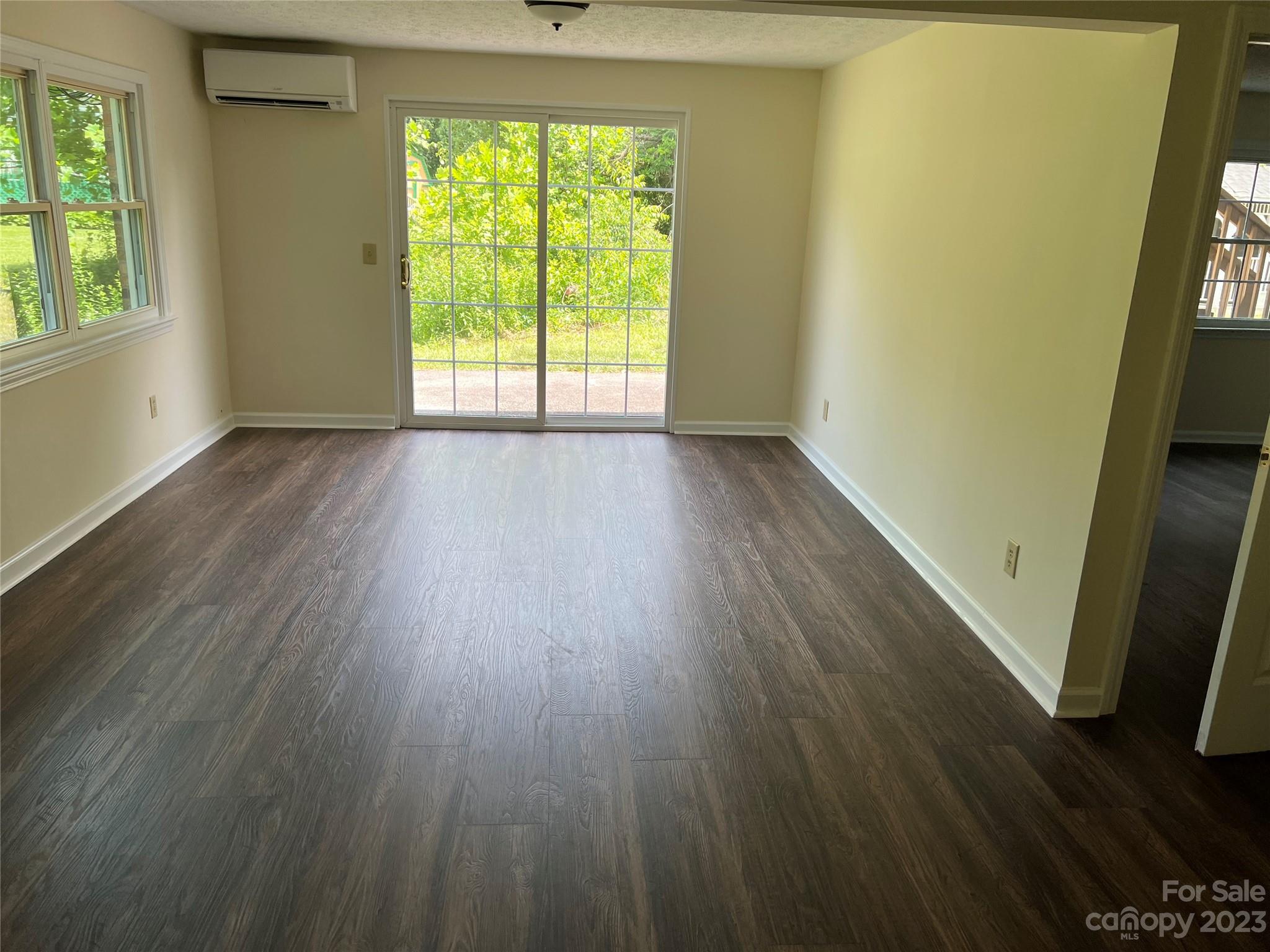 980 Brookside Camp Road Hendersonville, NC 28792 - Photo 39 of 47 a view of an empty room with wooden floor and a window