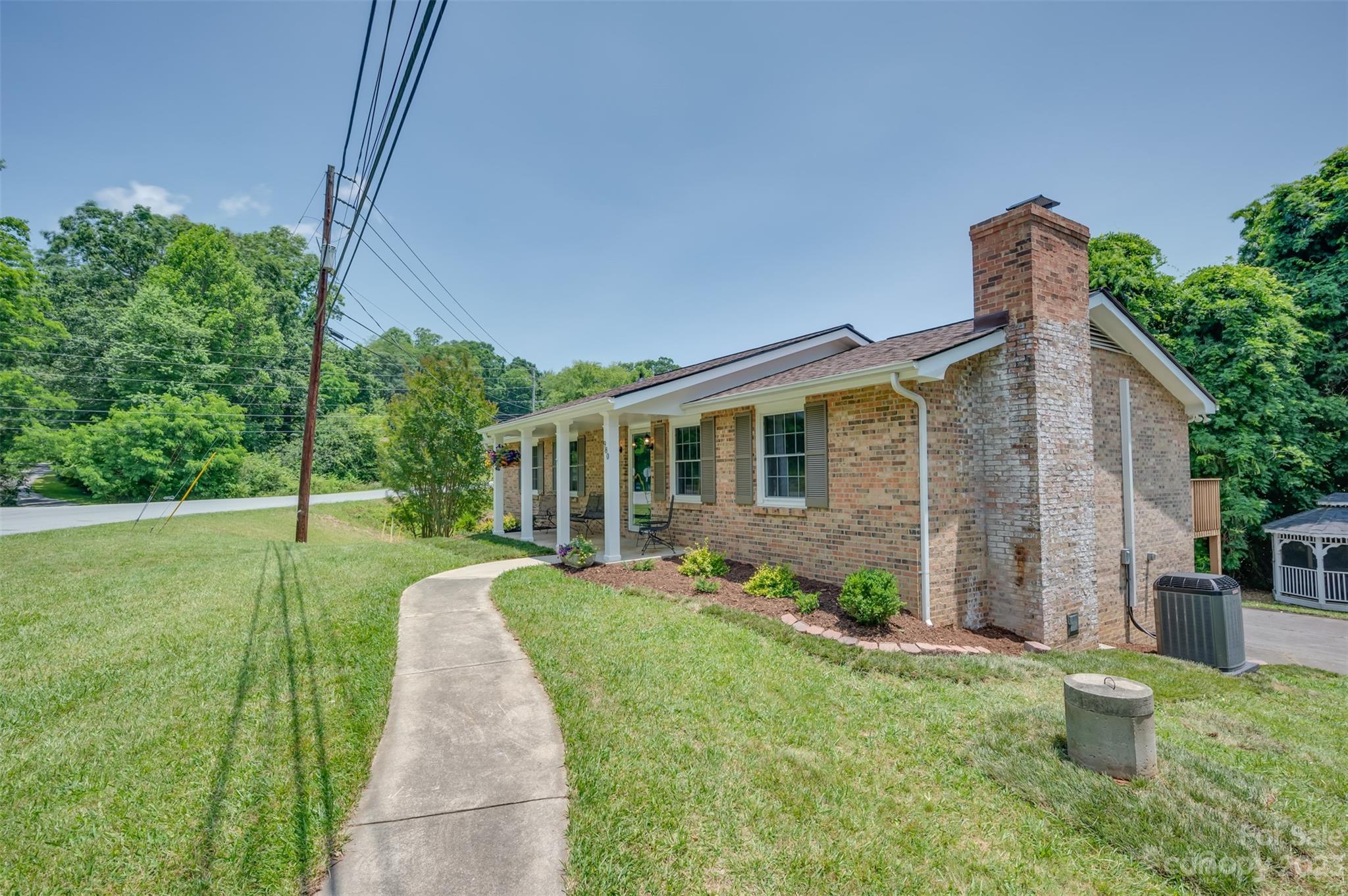 980 Brookside Camp Road Hendersonville, NC 28792 - Photo 4 of 47 a front view of a house with garden
