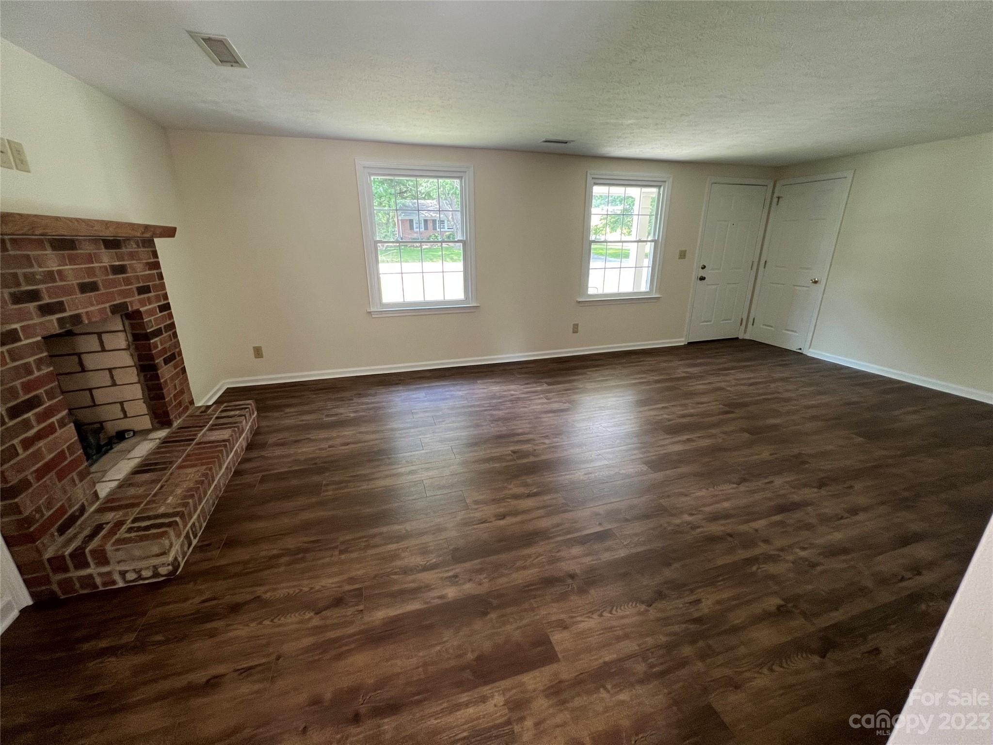980 Brookside Camp Road Hendersonville, NC 28792 - Photo 41 of 47 an empty room with wooden floor and windows