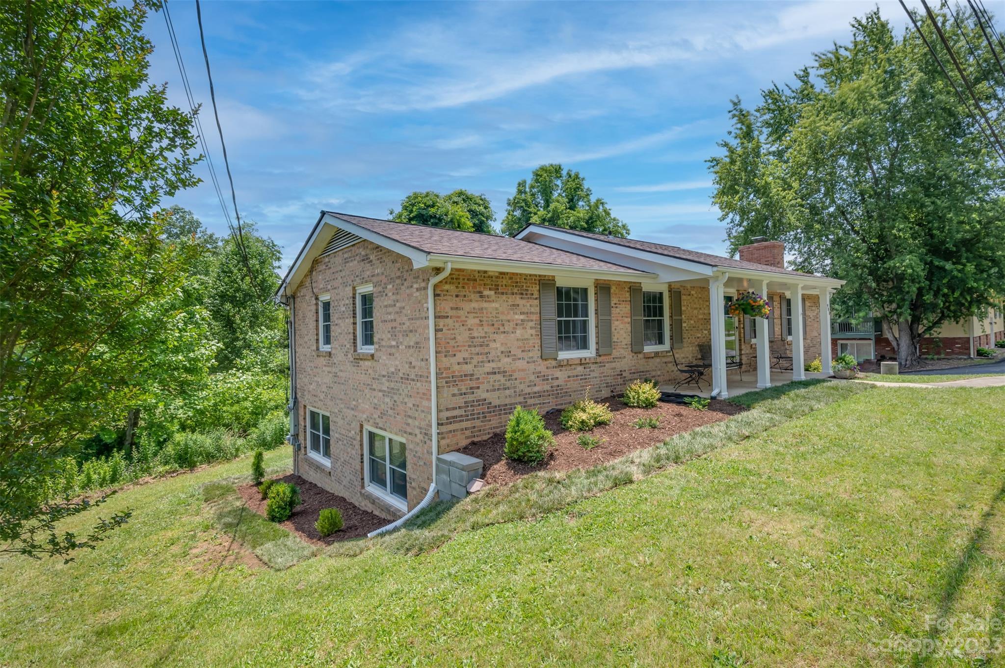 980 Brookside Camp Road Hendersonville, NC 28792 - Photo 5 of 47 a view of a house with a yard and plants