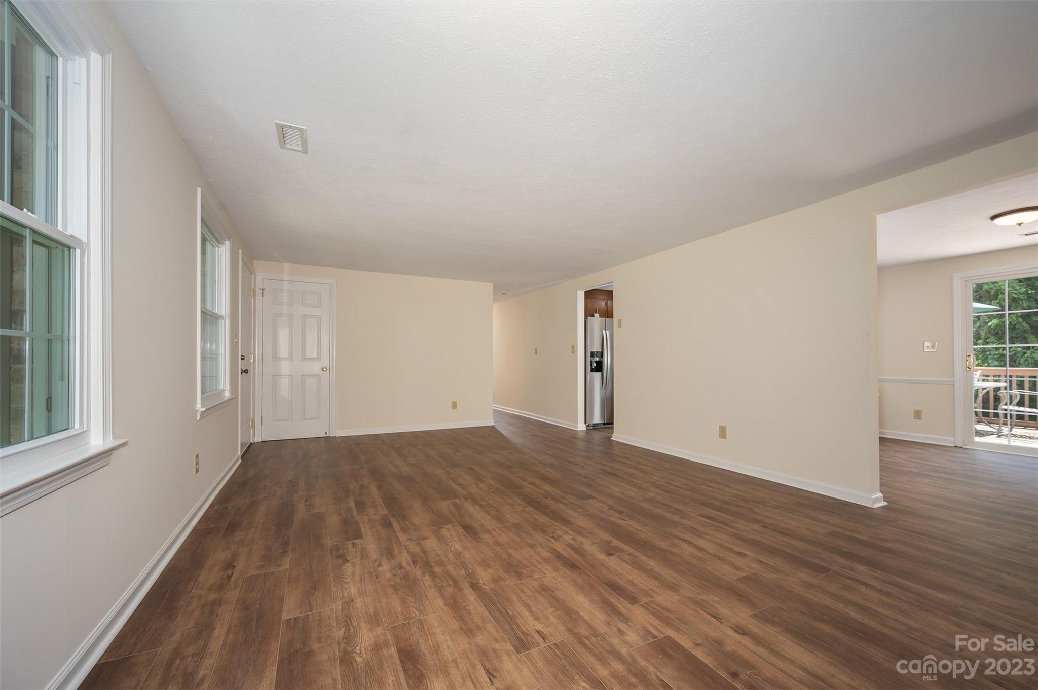 980 Brookside Camp Road Hendersonville, NC 28792 - Photo 8 of 47 a view of an empty room with wooden floor and a window