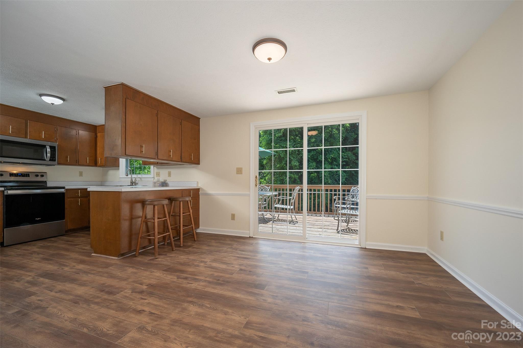 980 Brookside Camp Road Hendersonville, NC 28792 - Photo 9 of 47 a kitchen with stainless steel appliances wooden cabinets a stove top oven a sink and dishwasher