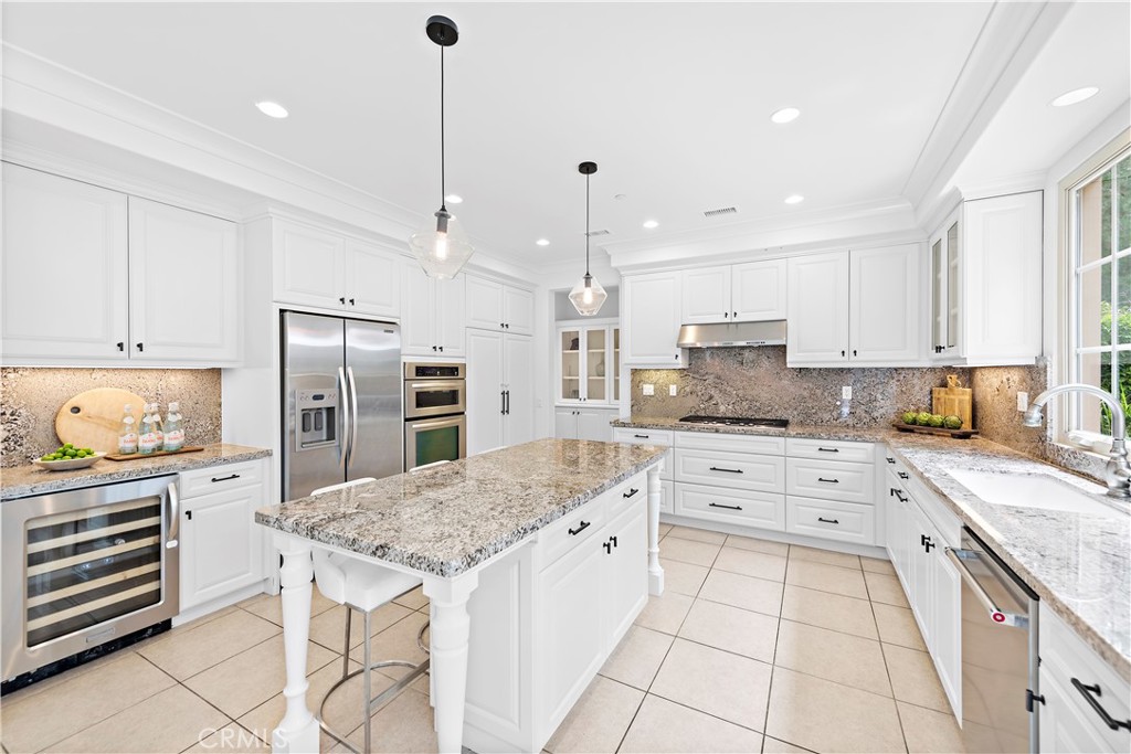 22 Tesoro Irvine, CA 92618 - Photo 5 of 27 a large kitchen with stainless steel appliances granite countertop a stove a sink and a refrigerator