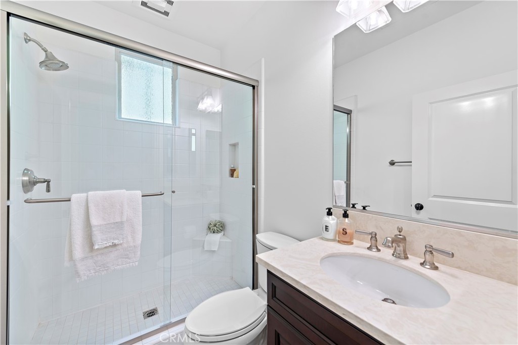 22 Tesoro Irvine, CA 92618 - Photo 7 of 27 a bathroom with a sink toilet a mirror and shower