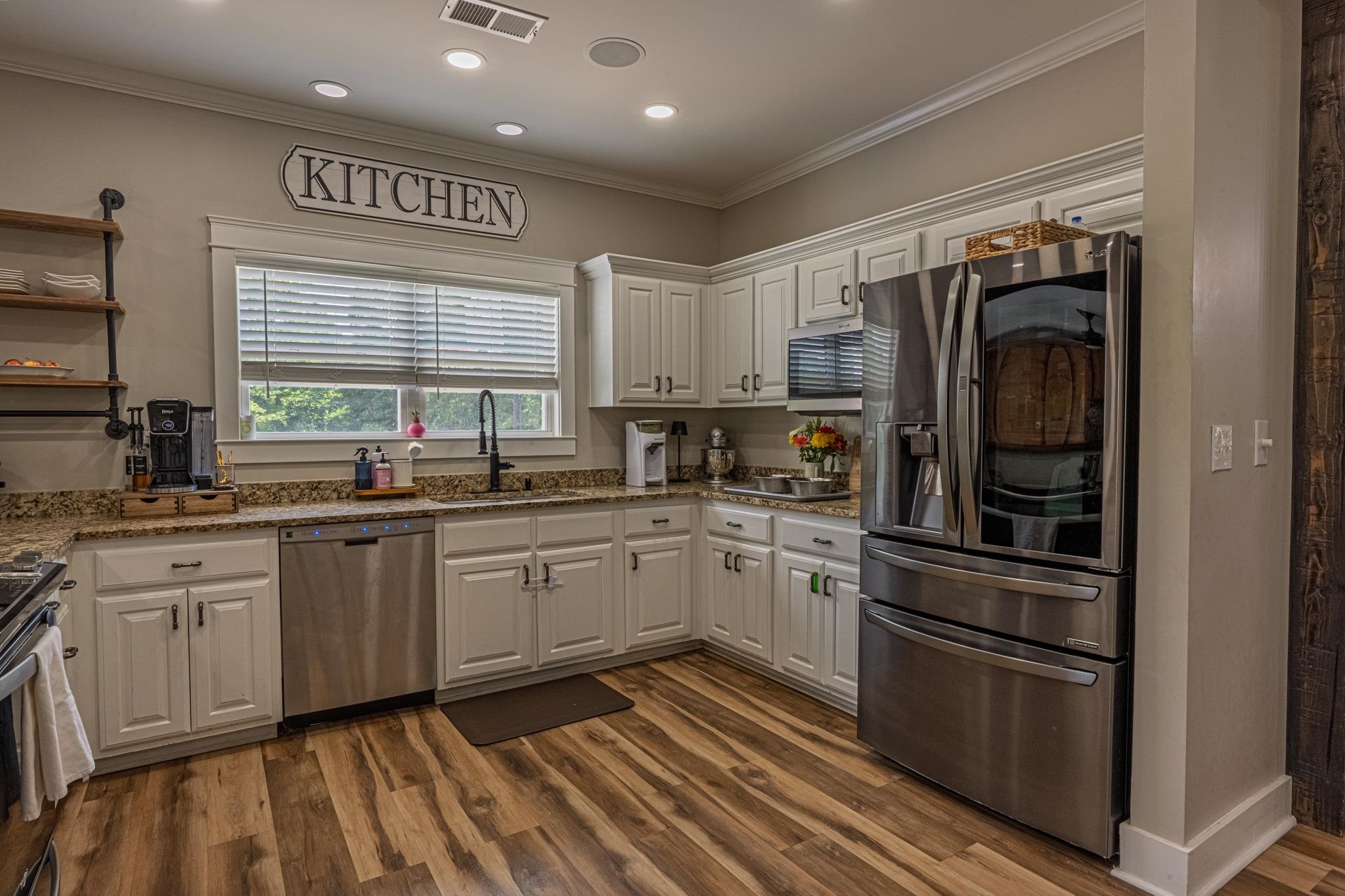 50 Shady Grove Road Williston, TN 38076 - Photo 16 of 35 a kitchen with granite countertop stainless steel appliances a sink and cabinets