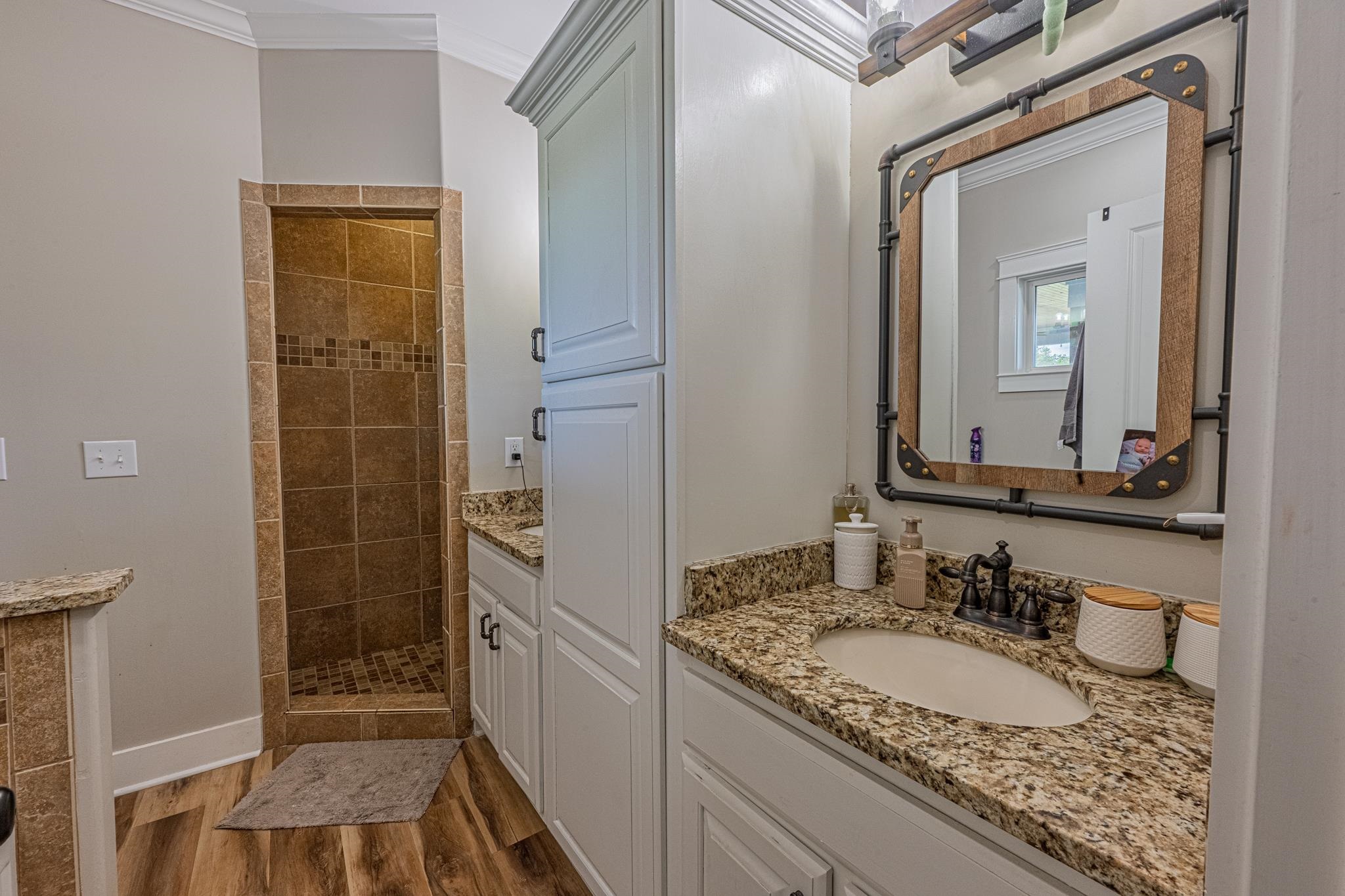 50 Shady Grove Road Williston, TN 38076 - Photo 28 of 35 a bathroom with a granite countertop sink and a mirror