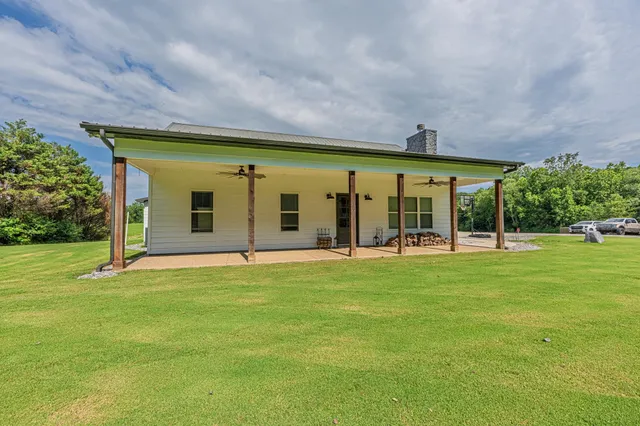 a backyard of a house with table and chairs