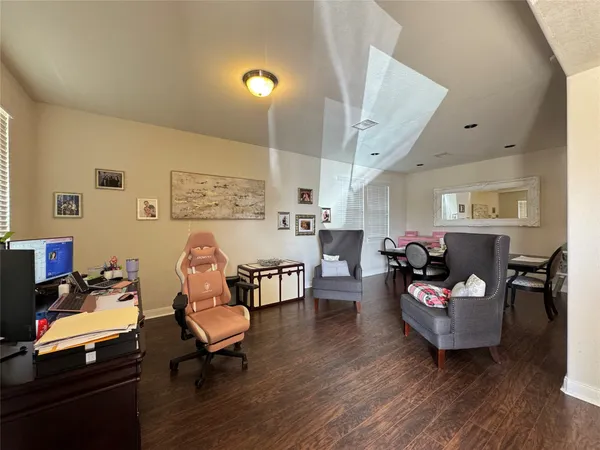 a living room with furniture and wooden floor