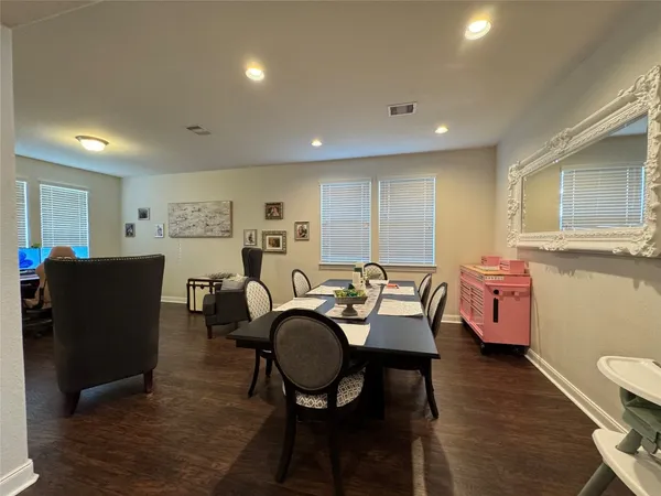a dining room with furniture and wooden floor