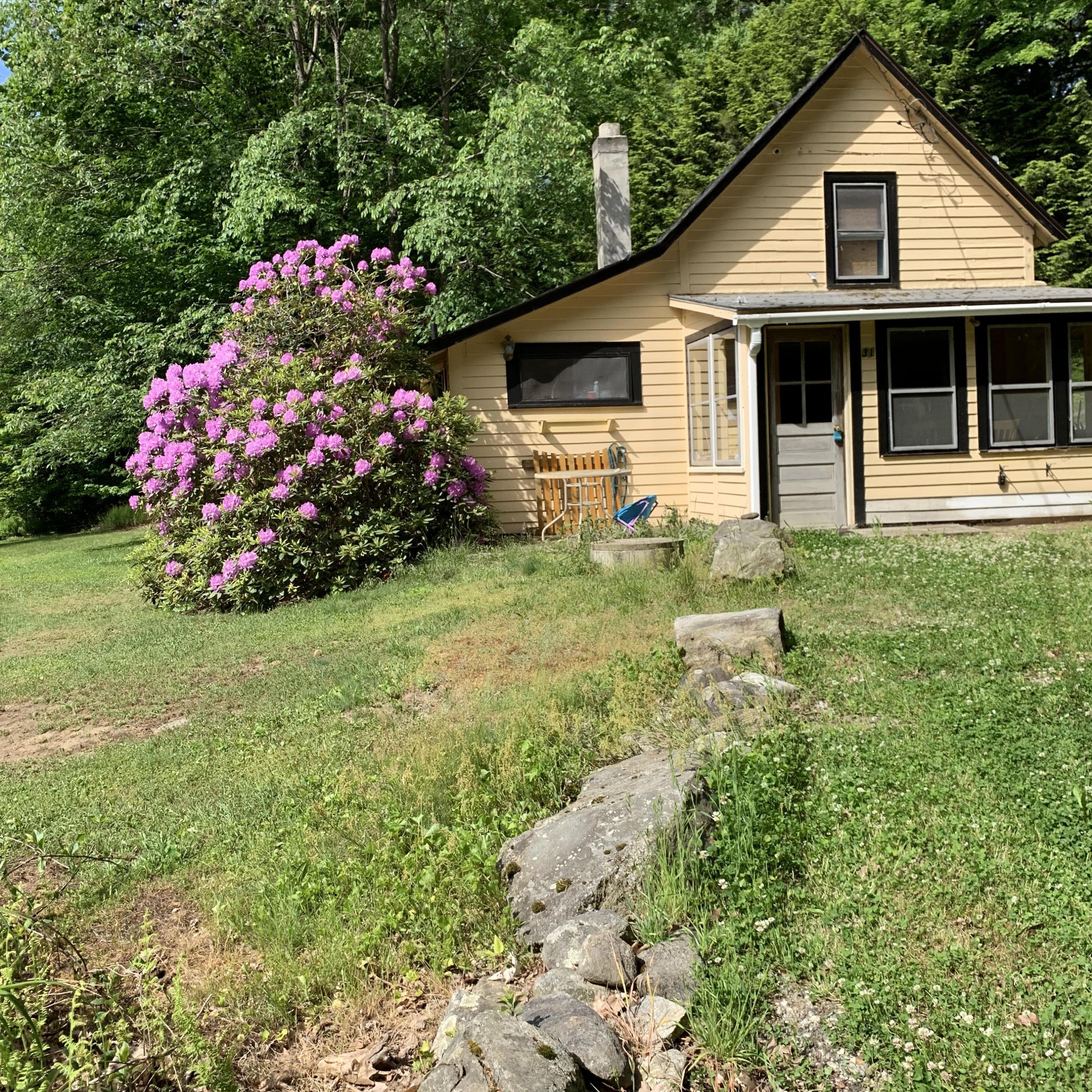 31 Lower Rainbow Road Otis, MA 01029 - Photo 1 of 15 a front view of a house with a yard and fountain