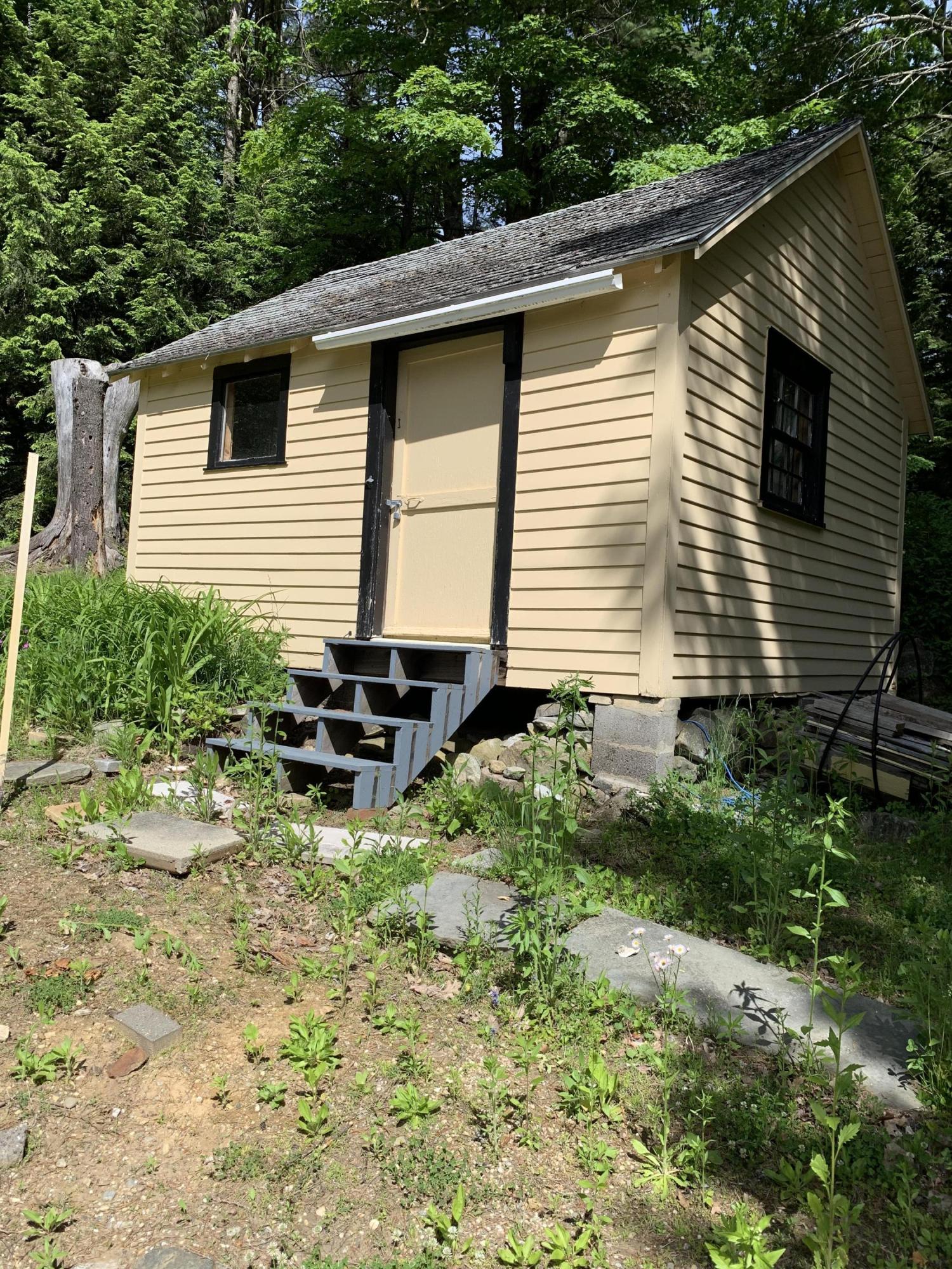 31 Lower Rainbow Road Otis, MA 01029 - Photo 12 of 15 a backyard of a house with table and chairs