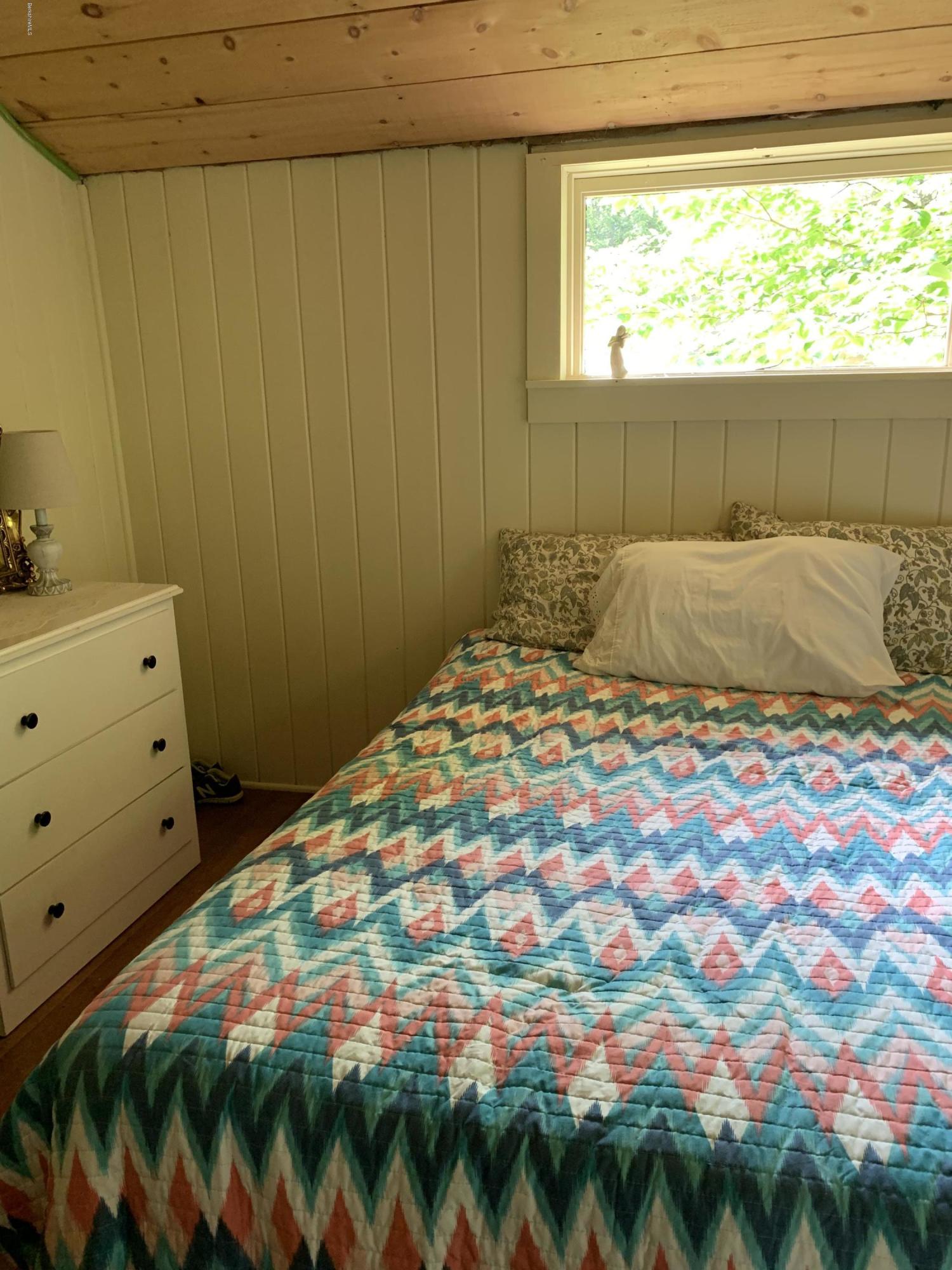 31 Lower Rainbow Road Otis, MA 01029 - Photo 9 of 15 a bedroom with a bed and a window