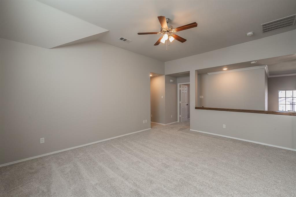 7305 Raintree Way Denton, TX 76210 - Photo 17 of 32 a view of an empty room with window and chandelier fan