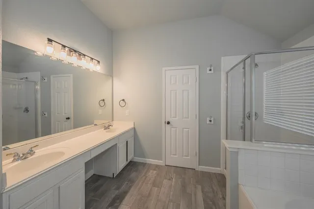 a bathroom with a double vanity sink and mirror