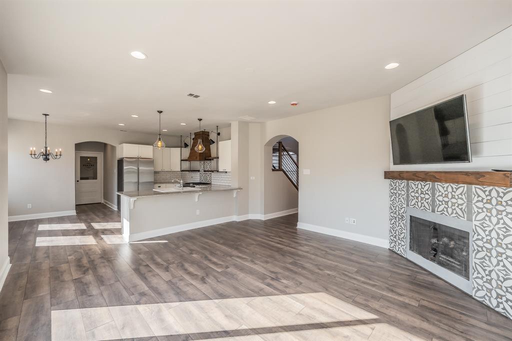 7305 Raintree Way Denton, TX 76210 - Photo 2 of 32 a view of kitchen with microwave a stove and a fireplace