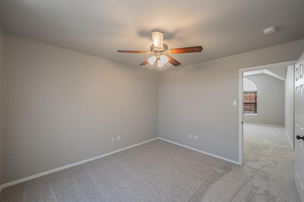 7305 Raintree Way Denton, TX 76210 - Photo 23 of 32 en empty room with windows and fan