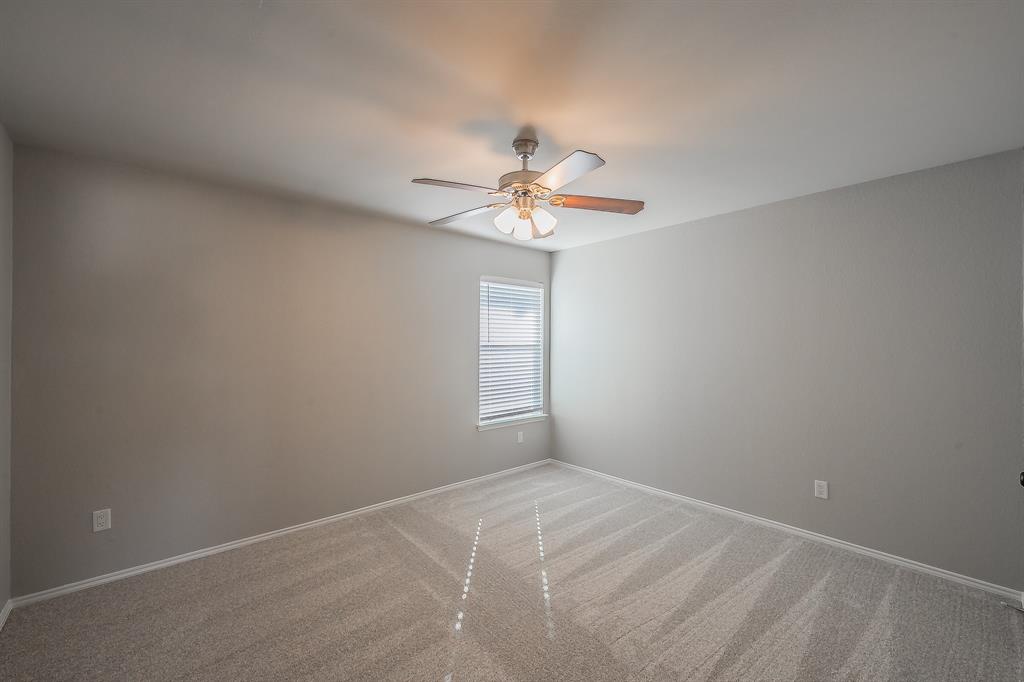 7305 Raintree Way Denton, TX 76210 - Photo 24 of 32 a view of a room with a window and a fan