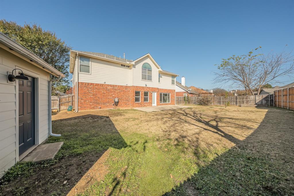 7305 Raintree Way Denton, TX 76210 - Photo 29 of 32 a front view of a house with a yard