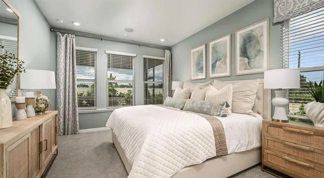 a bedroom with a large bed and a large window