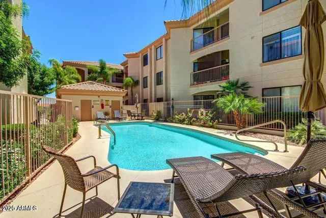 a view of a patio with table and chairs with wooden floor and fence