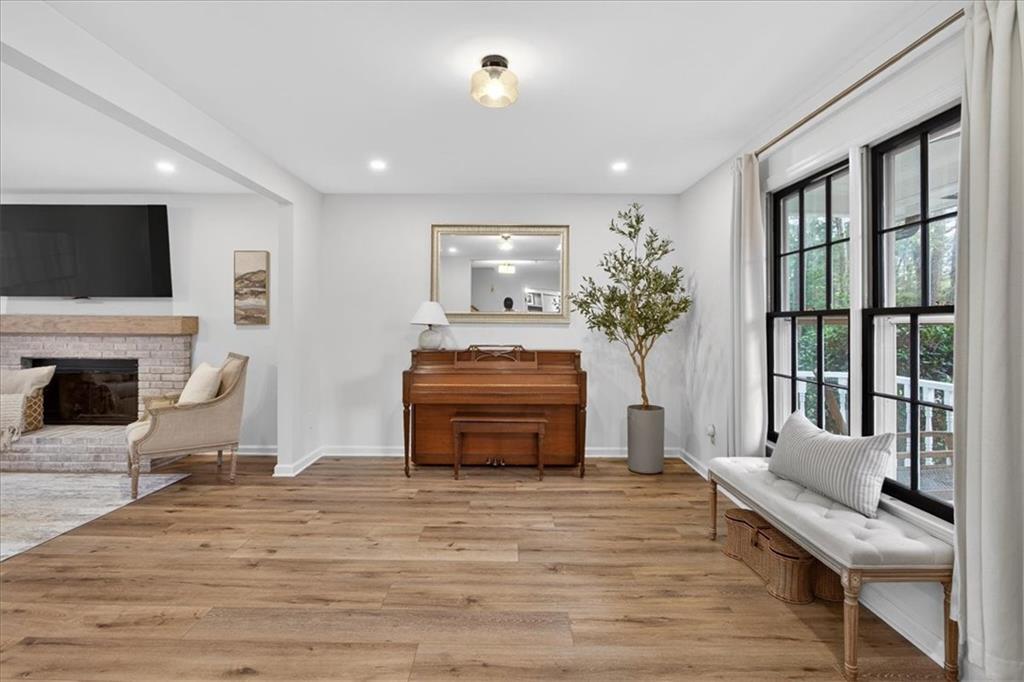 16145 Henderson Road Alpharetta, GA 30004 - Photo 11 of 61 a living room with furniture and a fireplace