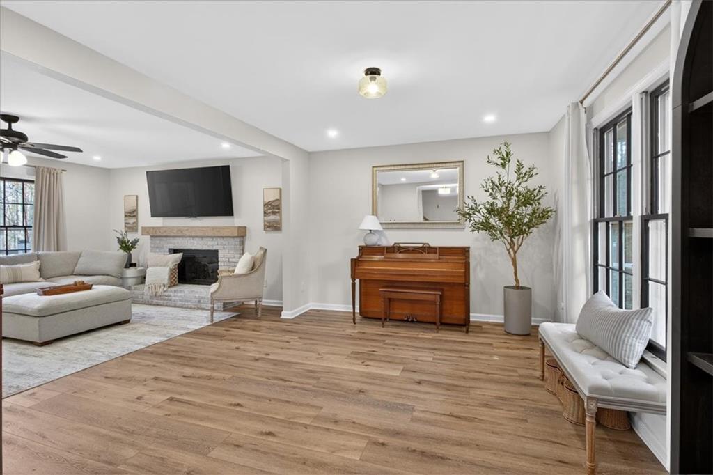 16145 Henderson Road Alpharetta, GA 30004 - Photo 12 of 61 a living room with furniture a fireplace and a flat screen tv