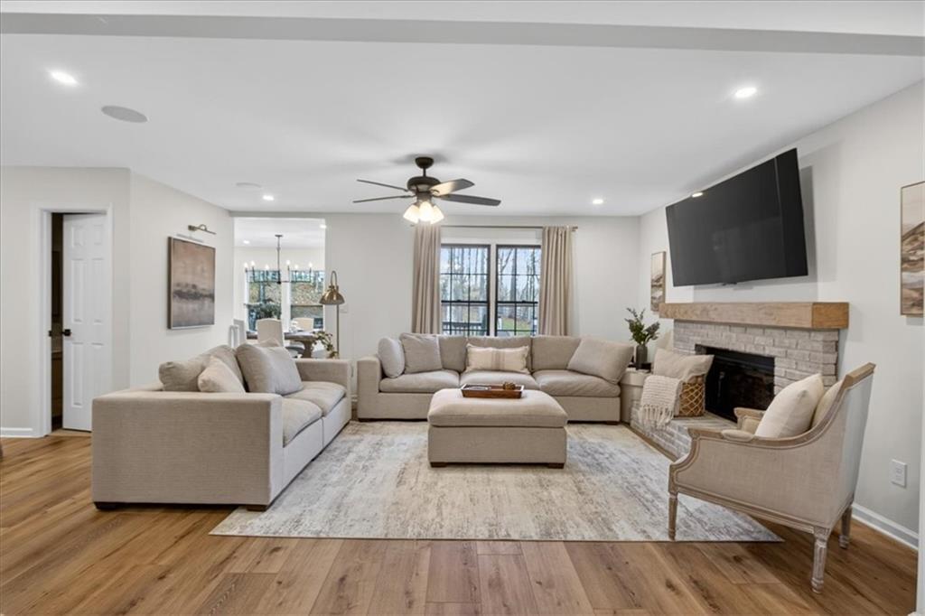 16145 Henderson Road Alpharetta, GA 30004 - Photo 13 of 61 a living room with furniture a fireplace and a flat screen tv