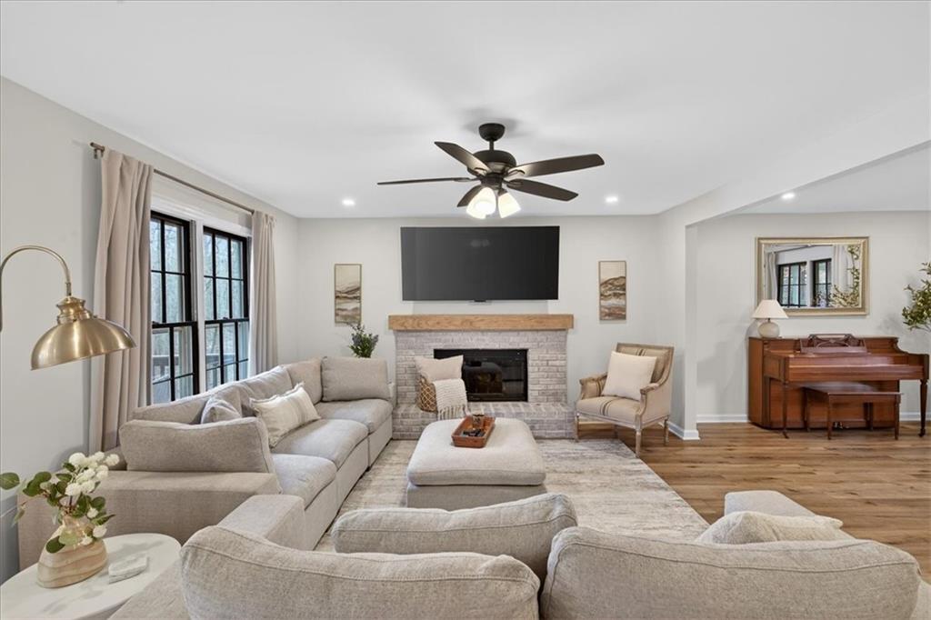 16145 Henderson Road Alpharetta, GA 30004 - Photo 14 of 61 a living room with furniture a fireplace and a flat screen tv