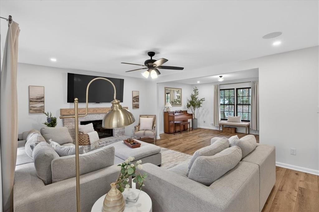 16145 Henderson Road Alpharetta, GA 30004 - Photo 15 of 61 a living room with furniture a fireplace and a chandelier