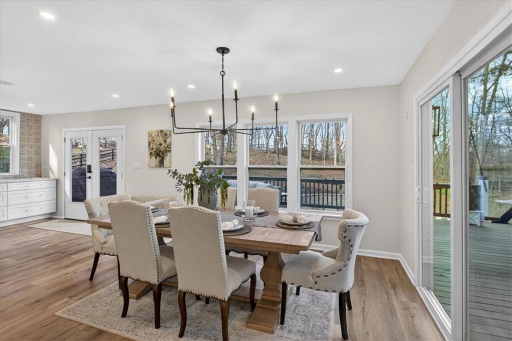 16145 Henderson Road Alpharetta, GA 30004 - Photo 16 of 61 a view of a dining room with furniture window and wooden floor