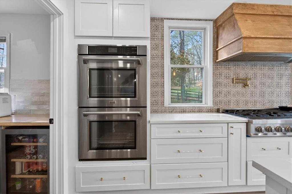 16145 Henderson Road Alpharetta, GA 30004 - Photo 22 of 61 a kitchen with granite countertop white cabinets and stainless steel appliances